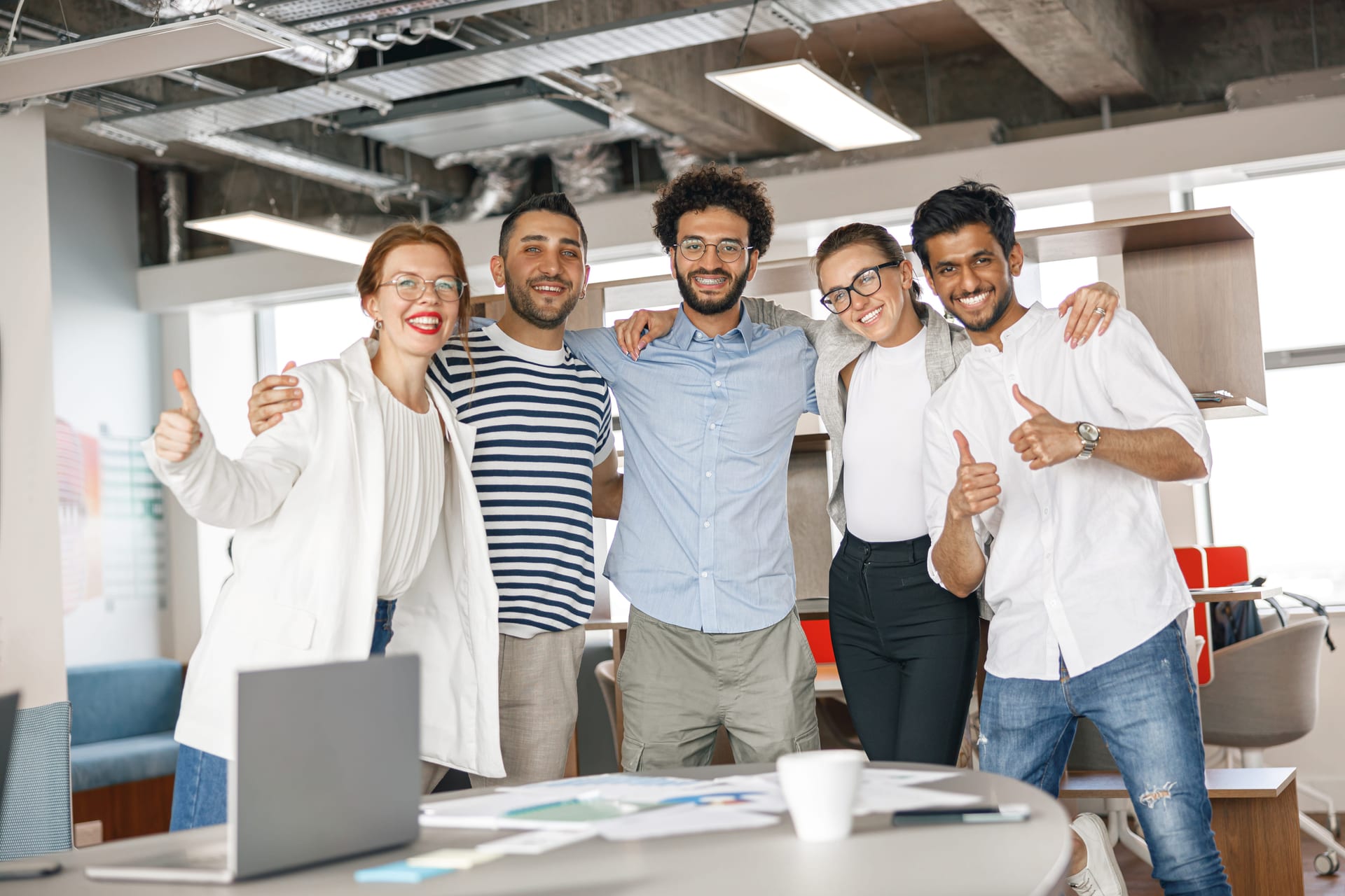 Diverse drug-free workplace team celebrating hiring success pre-employment screening