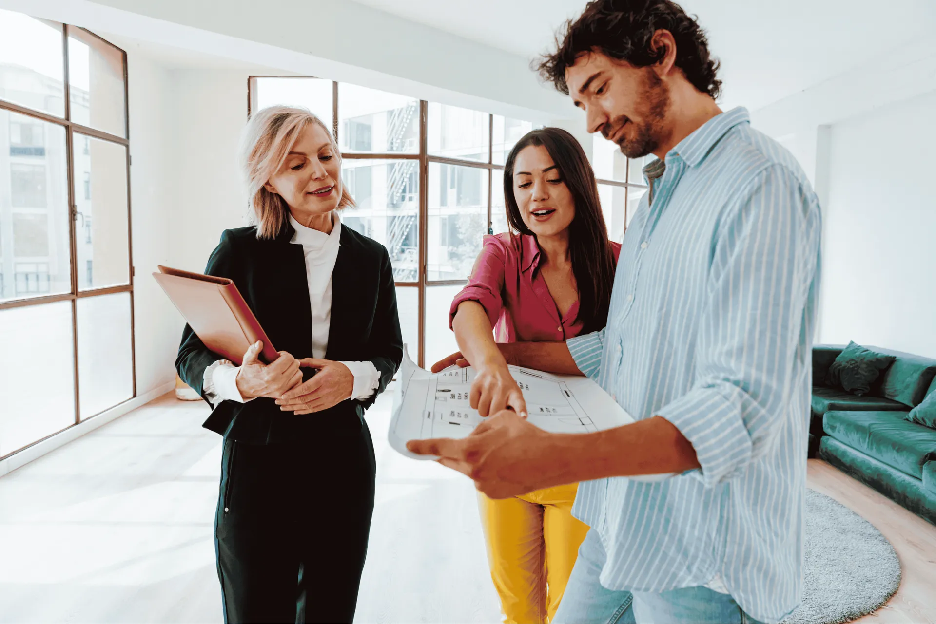 Property manager reviewing lease documents and floor plans with prospective tenants, representing protection for your property and reputation.